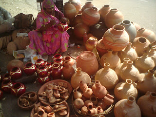 A Woman gives finishing touches to the pots in Jaipur