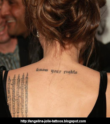 Gothic letter tattoo between her shoulder blades says "Know Your Rights".