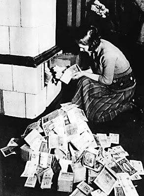 Weimar-Republic-Lady-Using-Money-To-Heat-Home-1923.jpg