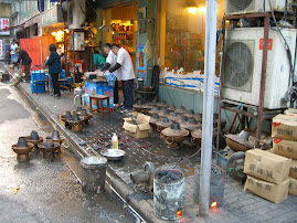 Street scene with cooking pots for dinner