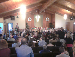 Packing 'em in for the preschool Christmas play.  My son is in there somewhere.