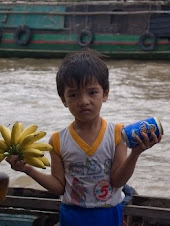 Vietnamese boy selling beer & bananas