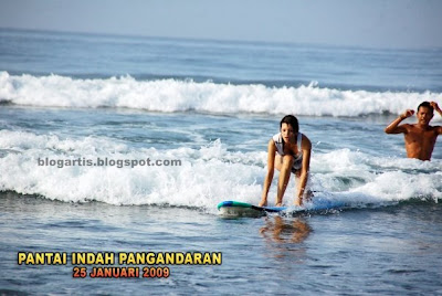 Farah Quinn surfing on the beach