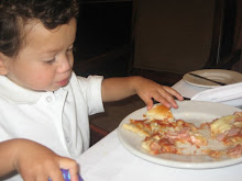 Eating his pizza