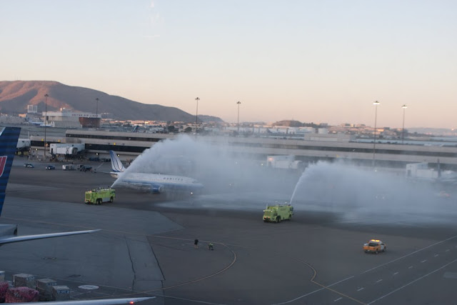 a firetruck spraying water on an airplane