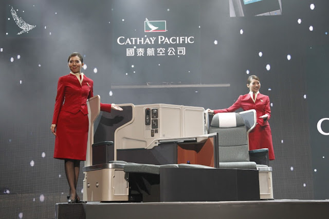 two women in red uniforms standing on a stage
