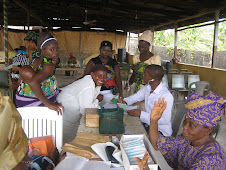 One of ICL's youth volunteers assisting at the mother and baby clinic...