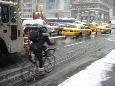 Image of bicyclist riding on snowy streets in New York City