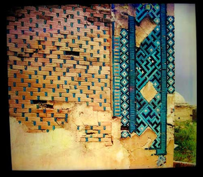 Colorful tile wall with patches of mortar in spots