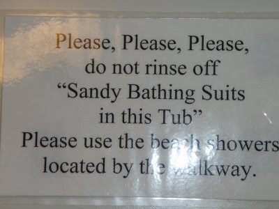 Laserprinted sign reading Please, Please, Please, do not rinse off 'Sandy Bathing Suits in this Tub' Please use the beach showers located by the walkway