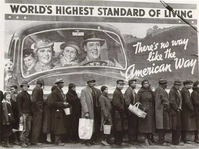 1930s black and white photo of a breadline in front of a happy billboard proclaiming There's no way like the American Way