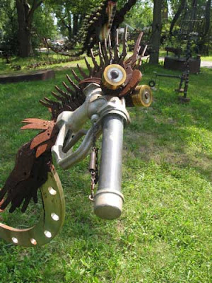 A bird's head made out of iron and other pieces of metal