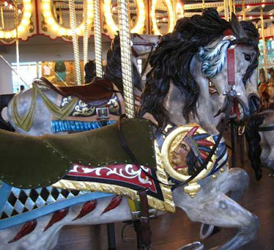 Carousel horse with an Indian chief's head with headress on the side