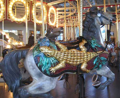 Carousel horse with a gold leaf alligator on its side