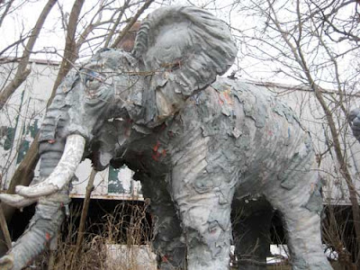 A fiberglass elephant with peeling paint