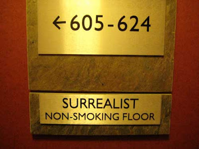 Brass wall sign reading Surrealist Nonsmoking Floor