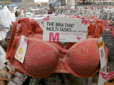 Photo of a red bra on a rack with a tag reading The Bra that Multitasks