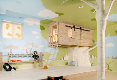 Photo of a child's fantasy room, featuring an indoor treehouse and walls painted to look like a forest