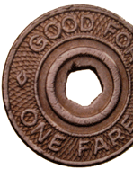 Close up of a metal token with pentagon-shaped cutout in the center