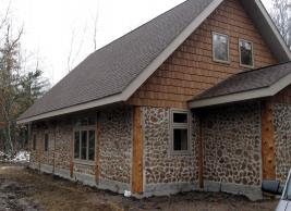 Exterior shot of a cord wood house -- looks very cozy!