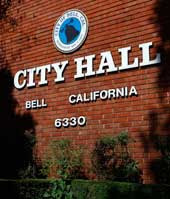 Brick wall with the words City Hall Bell California on it