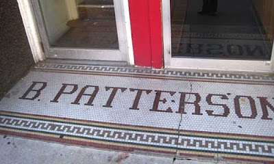 B. Patterson in dime tile outside a business door