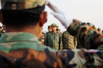 Photo by: Sovan Philong A soldier salutes Minister of Defence Tea Banh in Kampong Chhnang province on Thursday. Cambodian officials on Sunday rejected concerns, reportedly voiced by ASEAN Secretary General Surin Pitsuwan, that the purpose of last weekโs military tests was to provoke Thailand.