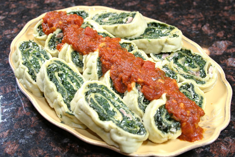 The Italian Dish Pasta Roll With Spinach and Tomato Sauce