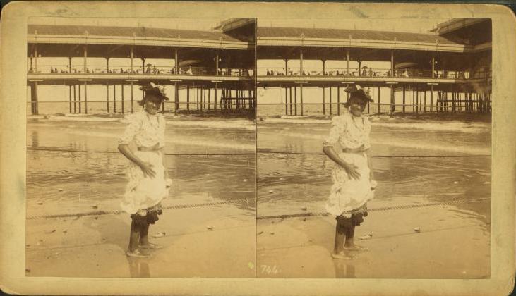 [Young+woman+wading+at+the+beach,+in+front+of+a+covered+pier.jpg]