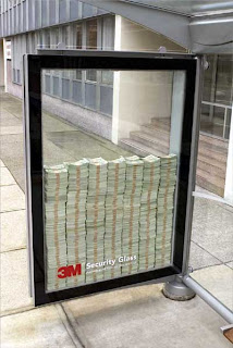 picture of a lot of money behind a security glass in front of a building