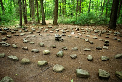 A spiral Labyrinth made of stones in the forest floor