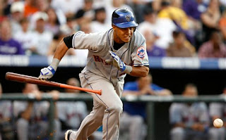 Carlos Gomez bunts for a base hit