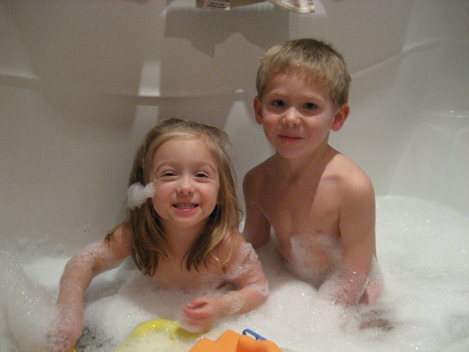 Brother and sister talking during bath time by Courtney 