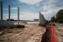 Opening at sound wall, east of Hwy. I-170 and Hanley Road, with construction underway