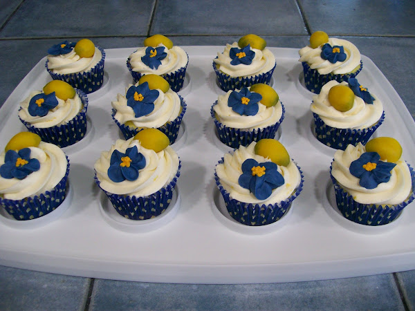 Lemon Cupcakes topped with Lemon Cream Cheese Icing       Marzipan Lemon & Royal Icing Flower