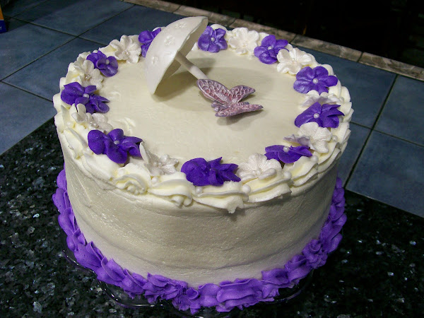Cake with gumpaste umbrella, butterfly & flowers