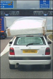 Driver held mattress on car roof Driver held mattress on car roof