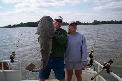 Capt. Dewayne Proffit with a nice Flathead he is holding up for his client