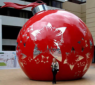 Women standing at a Giant Christmas Bauble hot photo