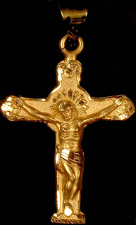 Lord Jesus Christ on Gold color cross shining with black background photo