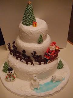 Christmas cake beautiful design with Christmas gifts, Christmas tree, and Santa Claus coming on the reindeer, and Iceman free religious Christmas pictures download