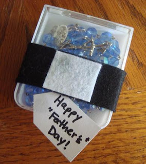 Felt clerical collar around box with rosary with happy Father's day tag