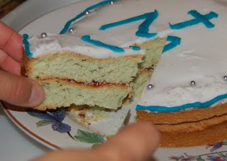 Slice of white cake with white and blue frosting