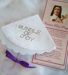 St. Therese prayer card next to umbrella-shaped invitation