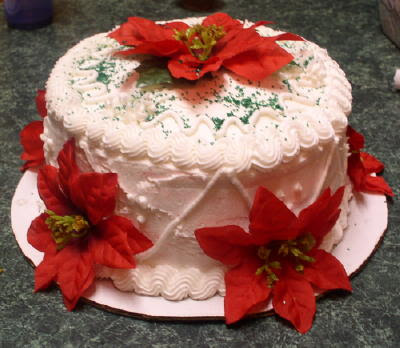 pictures of cakes decorated. White cream based cakes decorated Poinsettia, snowman, stars, snowflakes, 