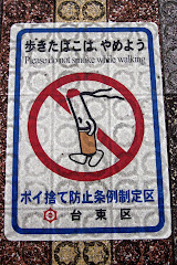 NO SMOKING sign on sidewalk