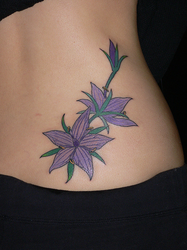 flower tattoos on side of hand. flower tattoos on side.