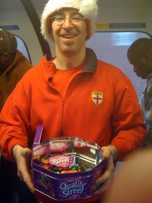 Central Line Tube Santa giving away Quality Street sweets