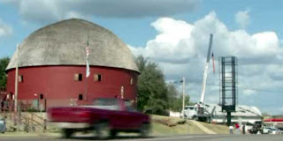 Billboard being erected beside Oklahoma's famous Round Barn