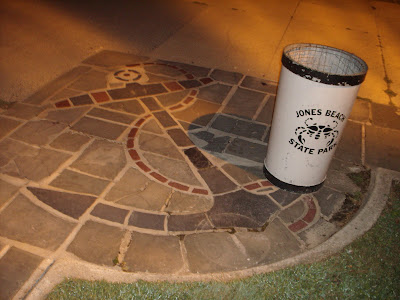 Anchor cement design in the ground corner of the open field in front of the beach.